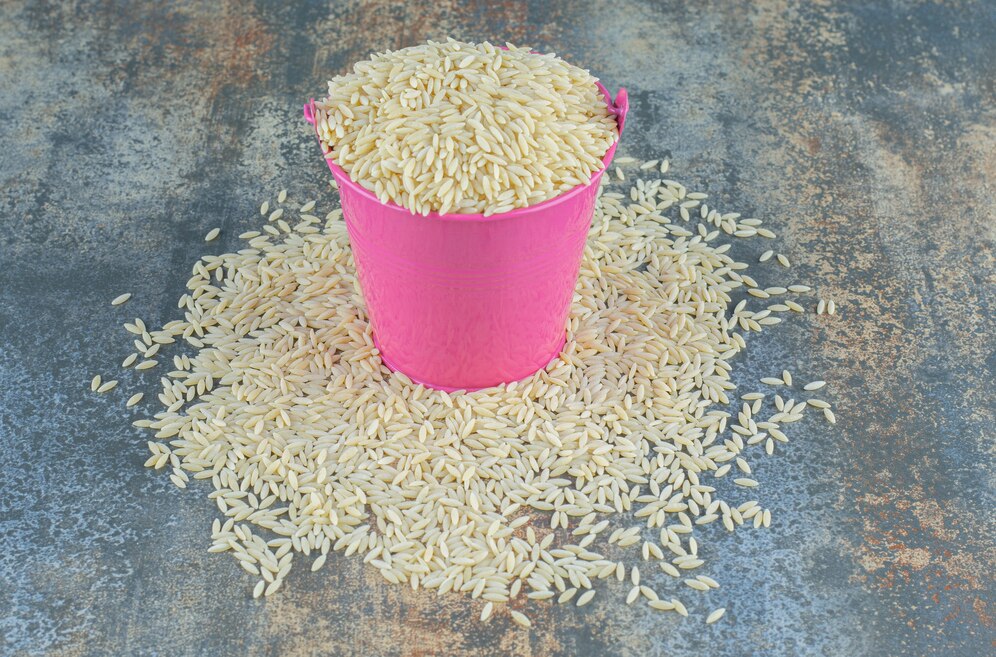 basmati-rice-spilled-from-bucket-marble-surface_114579-80835