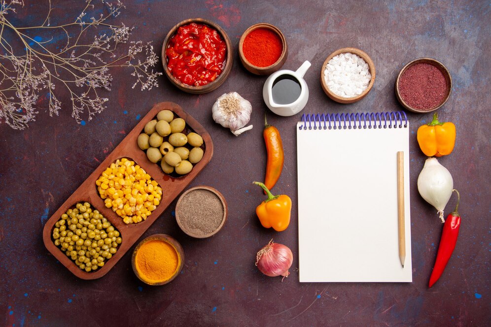 top-view-different-seasonings-with-vegetables-dark-space_140725-76039